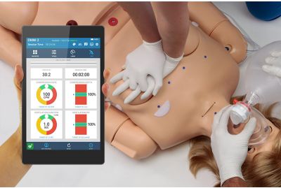 Learners perform CPR on SUPER CHLOE patient simulator while instructor tracks the quality on handheld OMNI2 controller